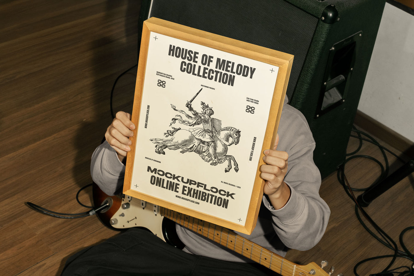 person holding a poster frame mockup in a music studio.