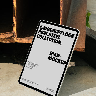 iPad mockup from Mockup Flock Real Steel Collection displayed on concrete floor with industrial rusted steel background for realistic branding presentation.