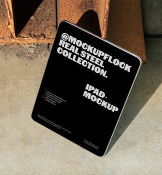 iPad mockup from Mockup Flock Real Steel Collection displayed on concrete floor with industrial rusted steel background for realistic branding presentation.