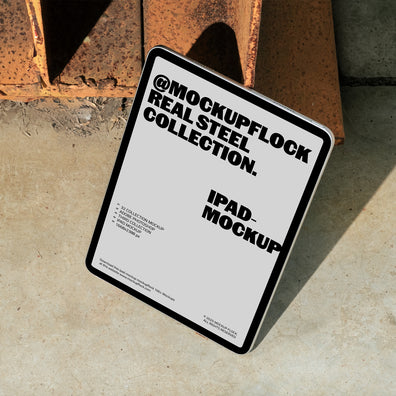 iPad mockup from Mockup Flock Real Steel Collection displayed on concrete floor with industrial rusted steel background for realistic branding presentation.