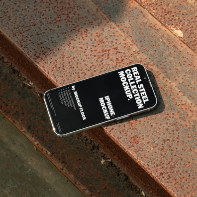 iPhone mockup from Mockup Flock Real Steel Collection placed on rusted steel surface for industrial-style product presentation.