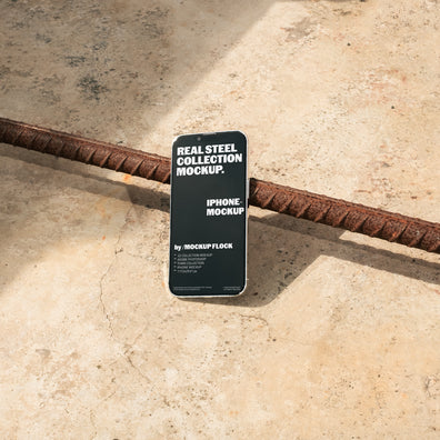 Mockup Flock Real Steel Collection Iphone mockup displayed on a concrete floor with industrial metal rods for realistic product presentation.