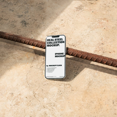 Mockup Flock Real Steel Collection Iphone mockup displayed on a concrete floor with industrial metal rods for realistic product presentation.