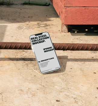 Mockup Flock Real Steel Collection Iphone mockup displayed on a concrete floor with industrial metal rods for realistic product presentation.