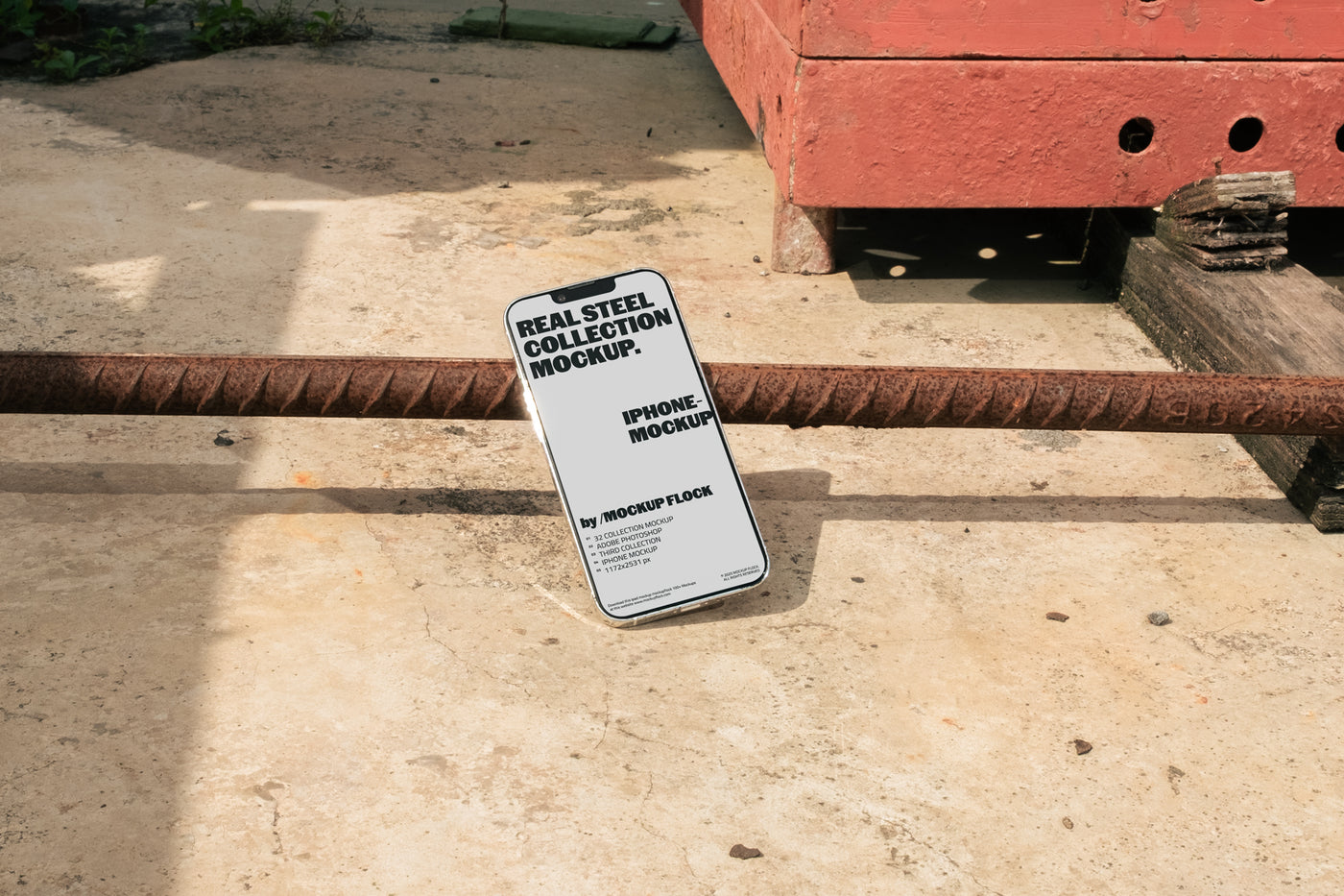 Mockup Flock Real Steel Collection Iphone mockup displayed on a concrete floor with industrial metal rods for realistic product presentation.