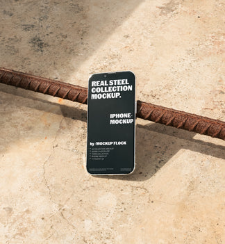 Mockup Flock Real Steel Collection Iphone mockup displayed on a concrete floor with industrial metal rods for realistic product presentation.