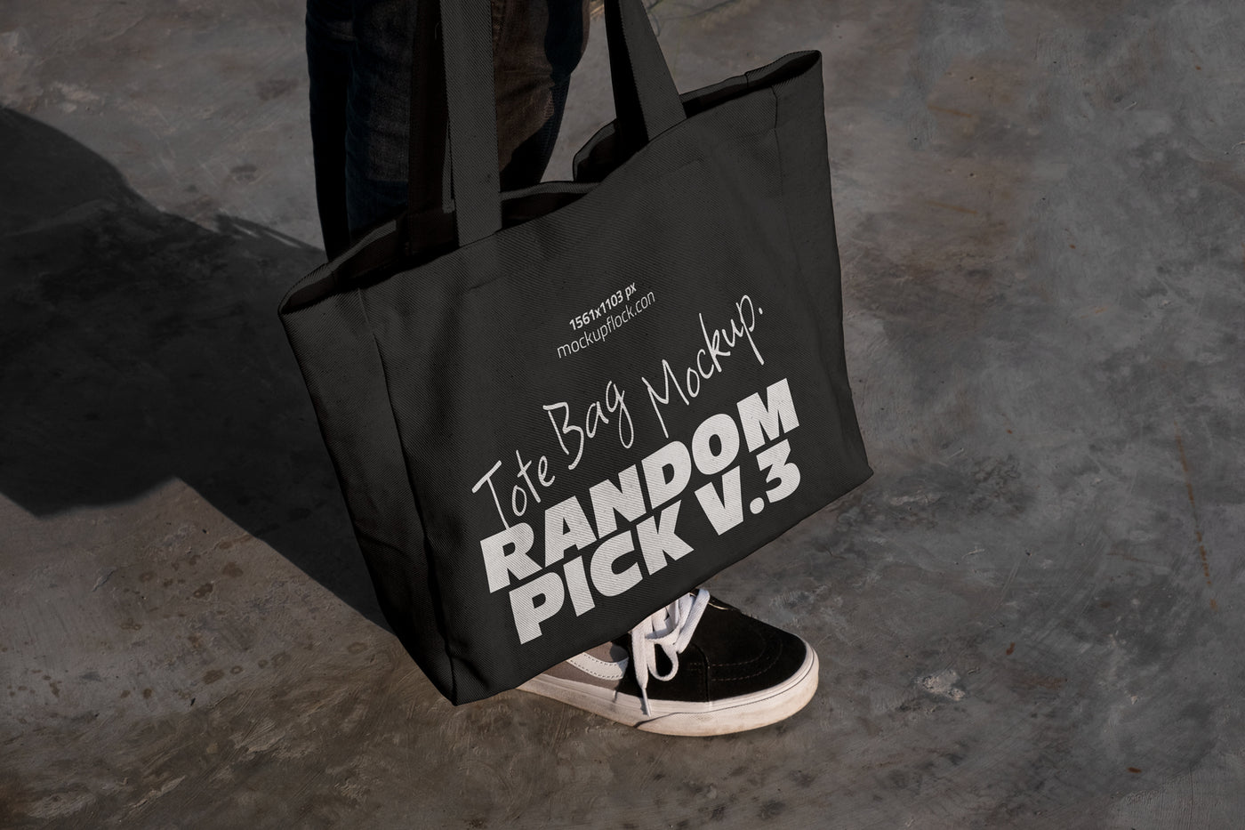 urban tote bag mockup lying on top of black shoes