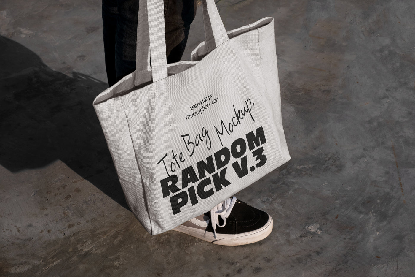 urban tote bag mockup lying on top of black shoes