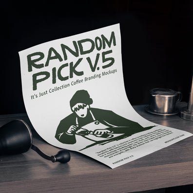 White A4 paper poster leaning upright on a dark wooden bar counter with a coffee grinder and Vietnamese drip filter beside it against a dark background for coffee brand poster mockup