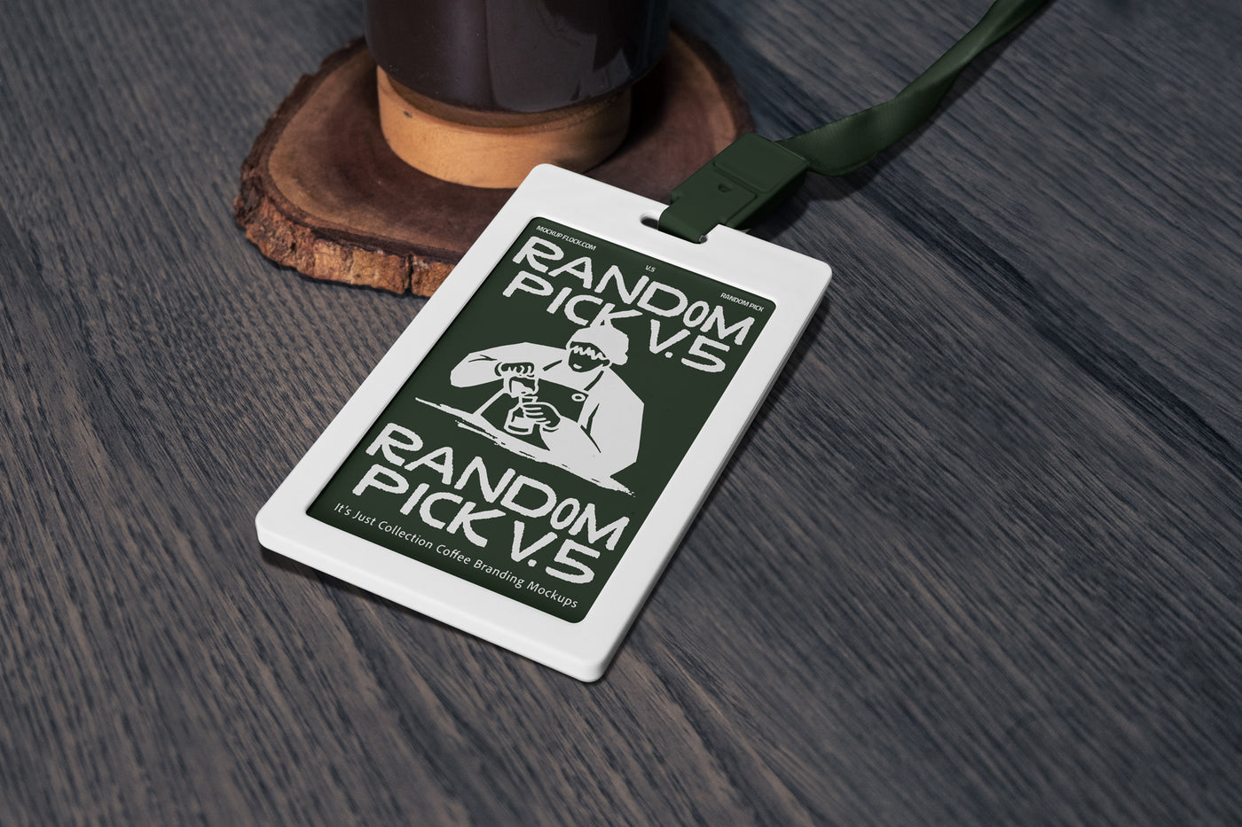 White ID badge card with dark green lanyard lying flat on a textured wooden surface next to a coffee grinder base, top angle flat lay mockup for cafe branding