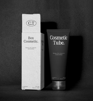 A black cosmetic tube labeled 'Cosmetic Tube.' stands next to a tall white box labeled 'Box Cosmetic.