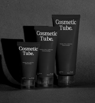 Three black cosmetic tubes labeled 'Cosmetic Tube.' standing on a dark surface against a dark gray background, with dramatic side shadows.