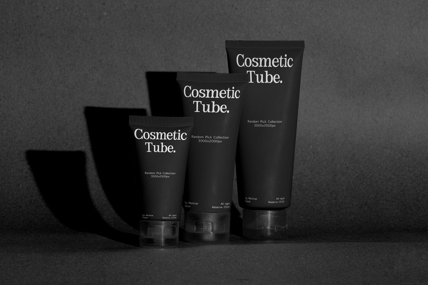 Three black cosmetic tubes labeled 'Cosmetic Tube.' standing on a dark surface against a dark gray background, with dramatic side shadows.