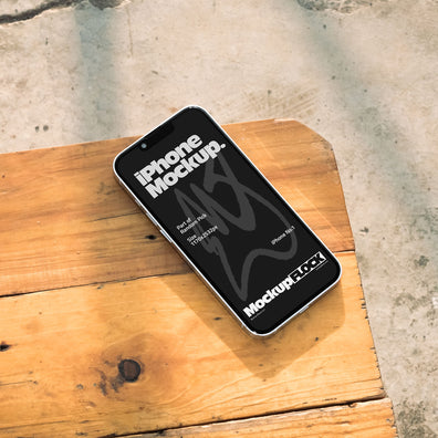 Realistic black iPhone mockup resting on a bright outdoor wooden bench with soft natural lighting and shadows