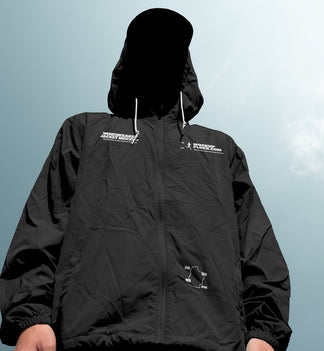 Black windbreaker jacket mockup low angle front view against sky