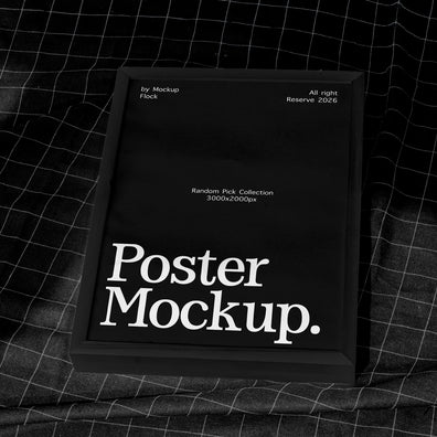 A black poster mockup frame with white text reading 'Poster Mockup.' placed on a dark gridded fabric surface.