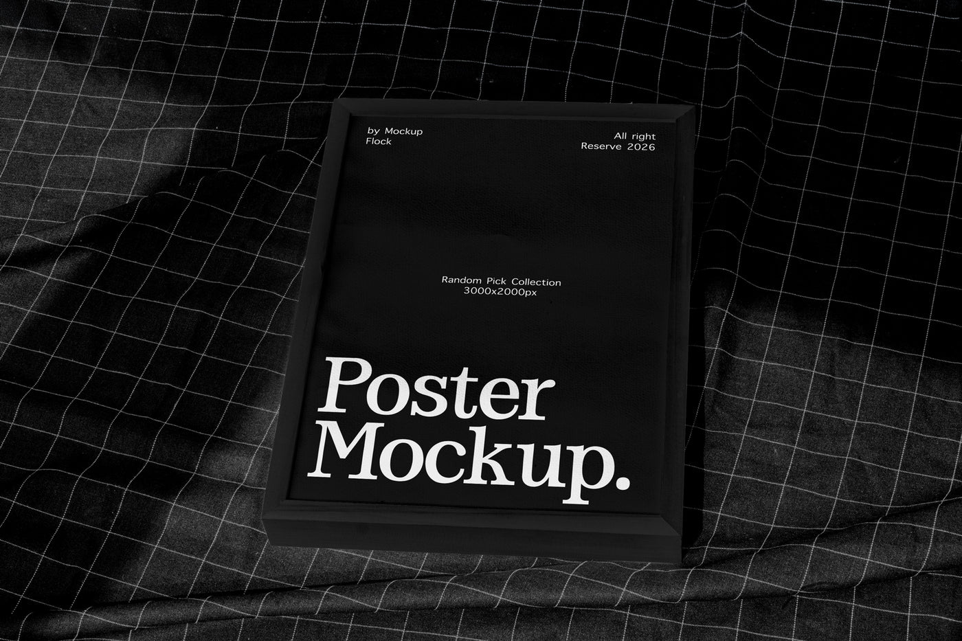 A black poster mockup frame with white text reading 'Poster Mockup.' placed on a dark gridded fabric surface.