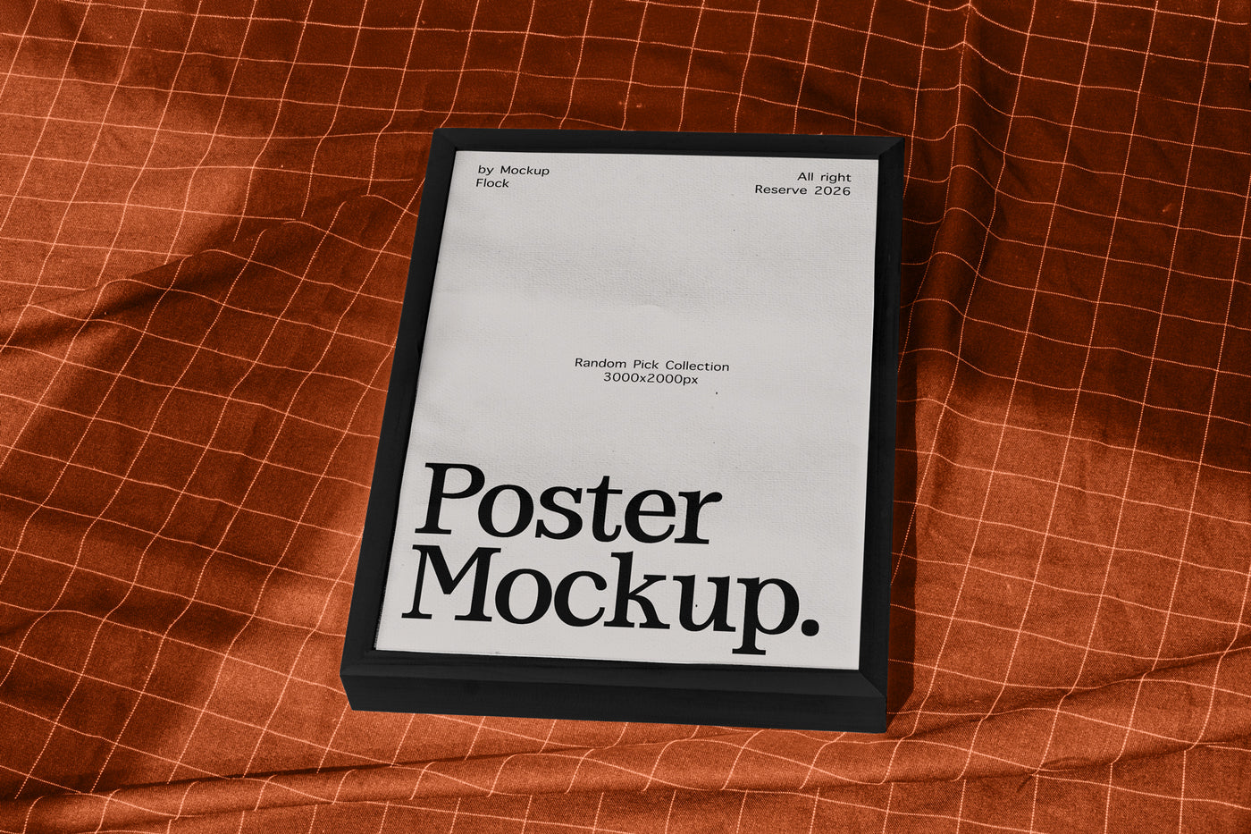 A framed poster mockup with a black frame and a white insert displaying the text 'Poster Mockup.' in bold black font, placed on an orange-brown textured fabric background with a grid pattern.