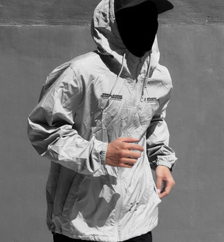 Black and white hooded jacket mockup front view with illustrated smiley face overlay on hood