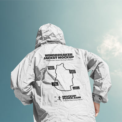 Black hooded jacket mockup back view against a gradient blue sky with clouds