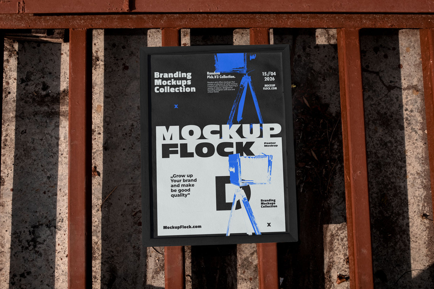 Framed poster mockup mounted on a rusty industrial metal fence outdoors in bright sunlight, bold black and white design with blue accents, urban street style branding