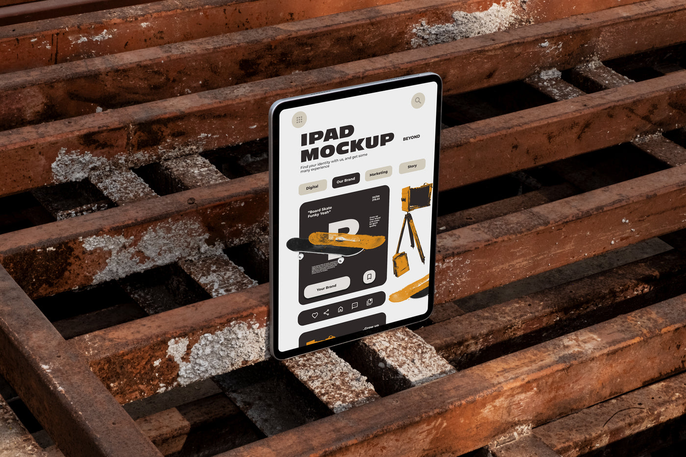iPad standing upright on rusty industrial metal pallets outdoors displaying app UI design, dark urban industrial style photography