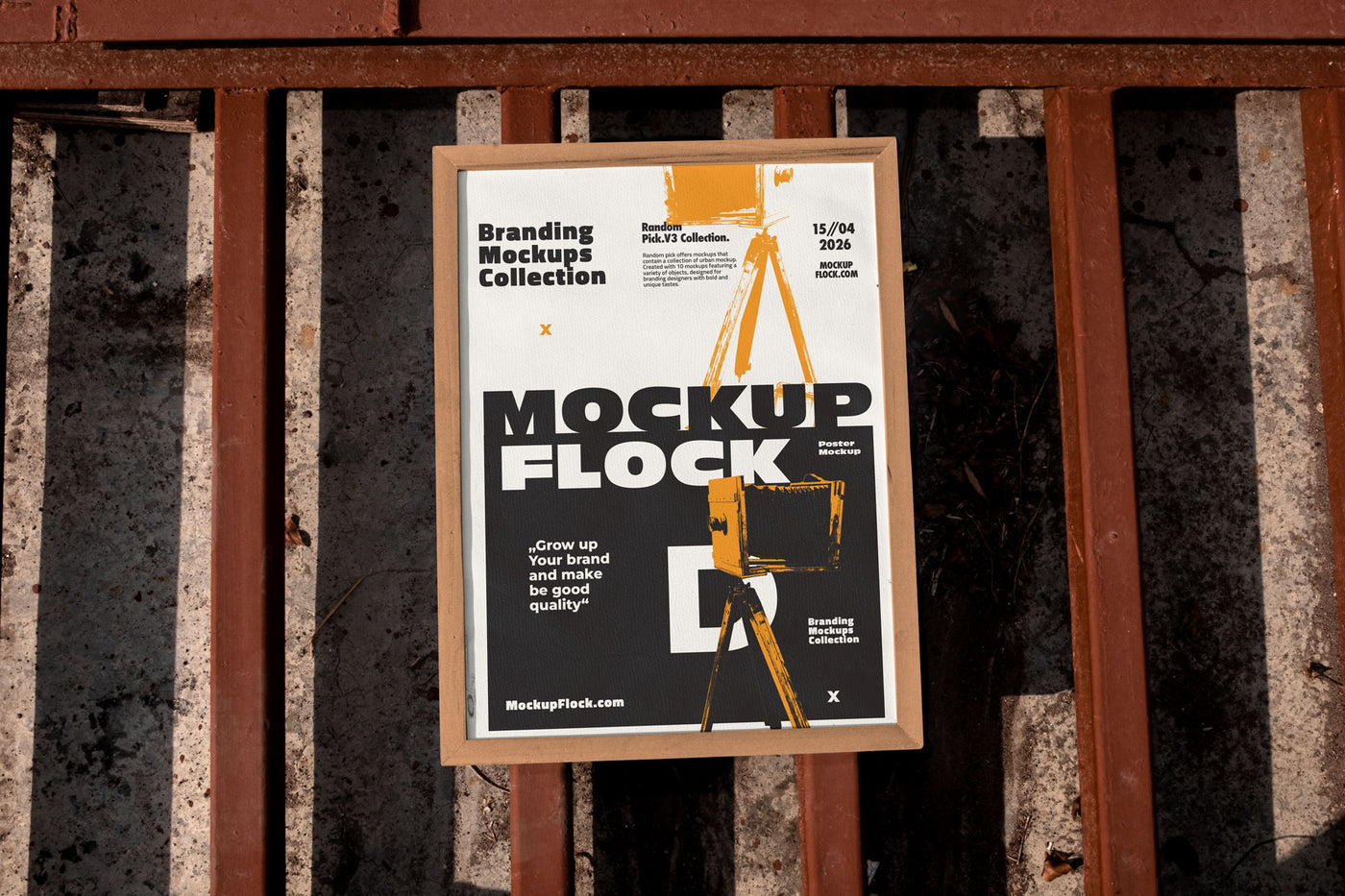 Framed poster mockup mounted on a rusty industrial metal fence outdoors in bright sunlight, bold black and white design with blue accents, urban street style branding
