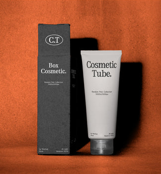 A white cosmetic tube labeled 'Cosmetic Tube.' stands next to a tall black box labeled 'Box Cosmetic.