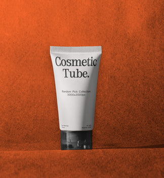 A white squeeze tube labeled 'Cosmetic Tube.' with black text, standing upright against a textured orange background.