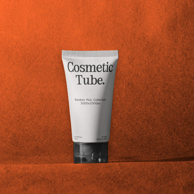 A white squeeze tube labeled 'Cosmetic Tube.' with black text, standing upright against a textured orange background.