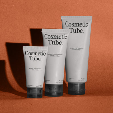 Three white cosmetic squeeze tubes with black caps and black text reading 'Cosmetic Tube.' arranged in a row against a warm terracotta background with cast shadows.