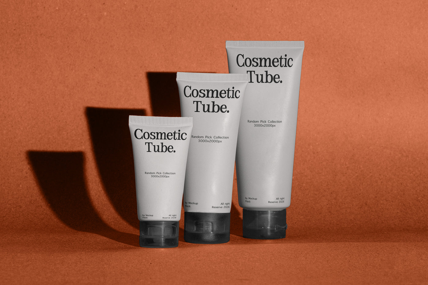 Three white cosmetic squeeze tubes with black caps and black text reading 'Cosmetic Tube.' arranged in a row against a warm terracotta background with cast shadows.