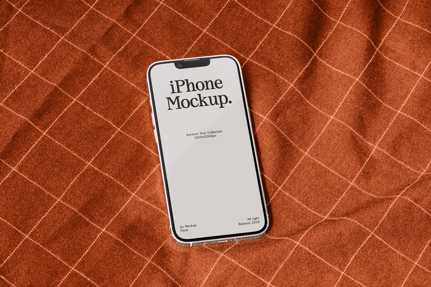 A smartphone mockup with a blank screen reading 'iPhone Mockup.' lies on a rust-orange textured fabric background with a white grid pattern.